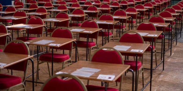 Empty exam hall with red chairs
