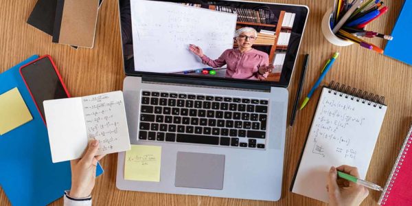remote tutoring with a tutor on screen and working at desk